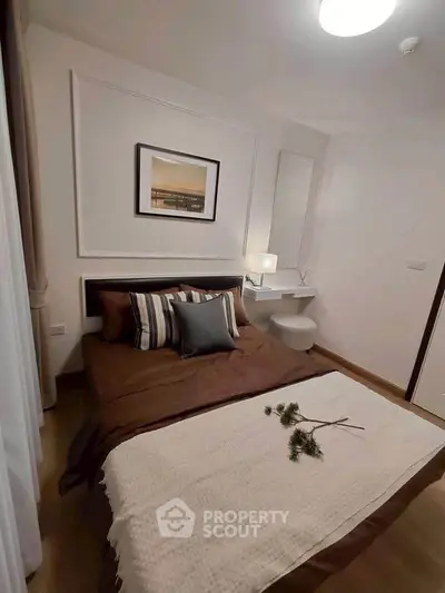 Cozy bedroom with stylish decor and warm lighting, perfect for relaxation.