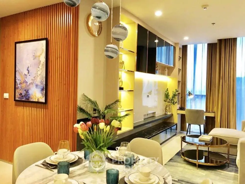 Luxurious modern living room with elegant decor and dining area, featuring stylish lighting and large windows.