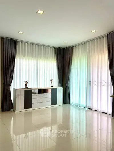 Spacious modern living room with elegant curtains and sleek flooring