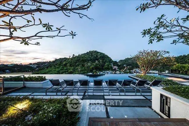 Stunning infinity pool with panoramic mountain view in luxury resort setting.
