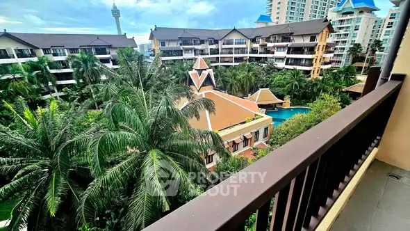 Stunning balcony view of lush gardens and luxurious residential complex.