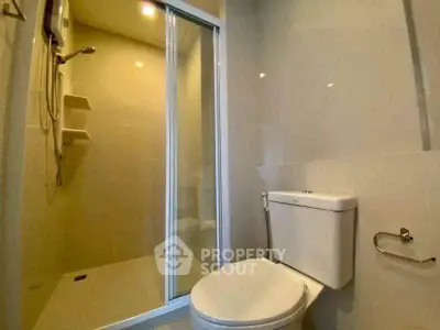 Modern bathroom with glass shower and sleek fixtures.