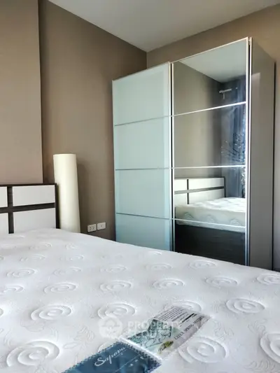 Modern bedroom with sleek wardrobe and comfortable bed in stylish apartment.