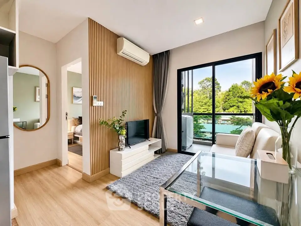 Modern living room with large window and stylish decor in a cozy apartment.