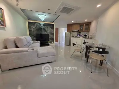 Spacious modern living room with elegant decor and open kitchen layout.