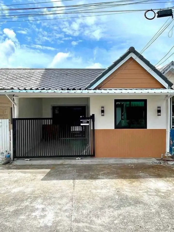 Charming single-story home with modern facade and gated entrance in a serene neighborhood.
