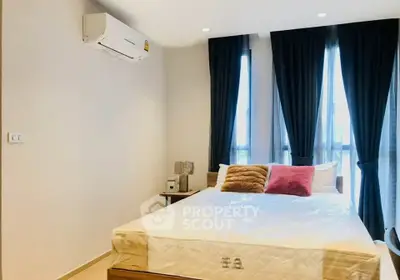 Modern bedroom with large windows, stylish curtains, and air conditioning unit.
