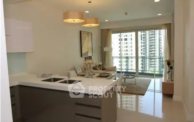 Modern open-plan kitchen and living room with balcony view in luxury apartment.
