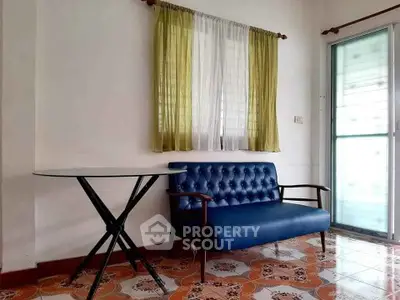Charming living room corner with vintage blue sofa and round table