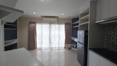 Modern kitchen with open layout and large windows for natural light