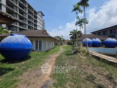 Explore this unique property with distinctive blue spherical structures and lush greenery, perfect for creative living.