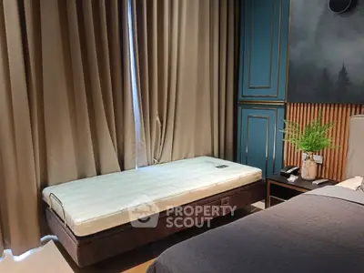 Elegant bedroom with stylish decor and cozy ambiance, featuring a comfortable bed and modern furnishings.