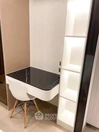 Modern study nook with sleek black marble desk and white shelving unit