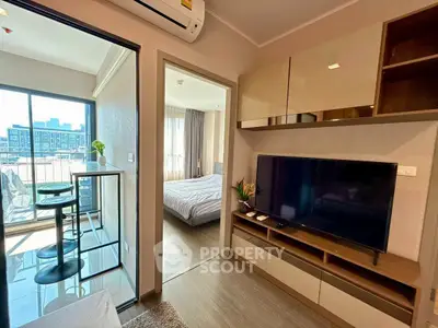 Modern apartment interior with living room, bedroom, and balcony view, featuring sleek furniture and natural light.