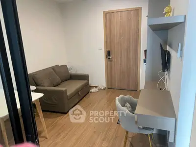 Cozy living room with modern decor and workspace, ideal for urban living.