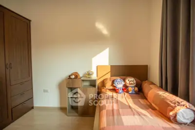 Cozy bedroom with wooden furniture and playful decor, perfect for a child's room.