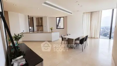 Spacious modern living room with open kitchen and stunning city view.