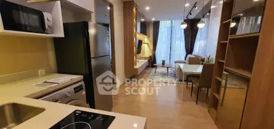 Modern open-layout kitchen and living room with sleek appliances and stylish decor