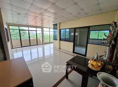 Spacious corner unit with large windows offering lush green views, ideal for a serene living space.