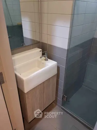 Modern bathroom with sleek sink and glass shower enclosure