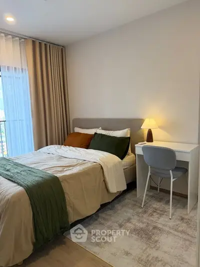 Cozy bedroom with modern decor, featuring a comfortable bed and a stylish desk by the window.