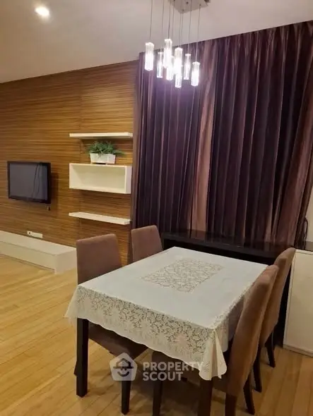 Elegant dining area with modern lighting and wooden accents