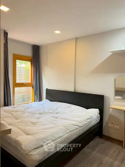 Cozy bedroom with modern decor and natural light from window