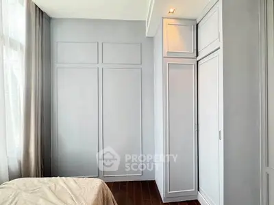 Spacious bedroom with elegant built-in wardrobes and large window for natural light.