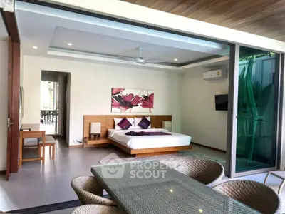 Luxurious bedroom with open layout and modern decor, featuring a spacious bed and stylish furniture.