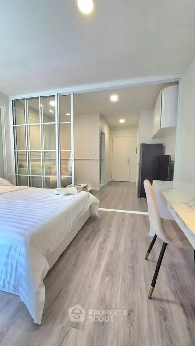 Modern studio apartment with sliding glass doors and stylish furnishings