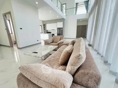 Spacious modern living room with high ceilings and elegant decor