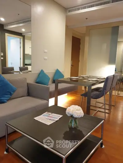 Modern living room with dining area, stylish furniture, and cozy ambiance in a contemporary apartment.