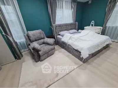 Luxurious bedroom with plush armchair and elegant decor