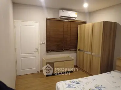 Cozy bedroom with wooden furniture and air conditioning in modern apartment