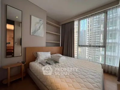 Modern bedroom with large window and stylish decor in urban apartment