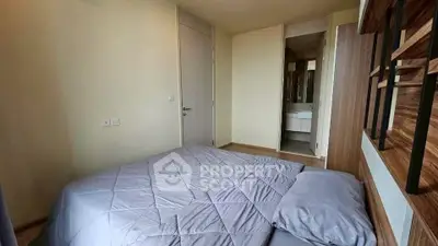 Cozy bedroom with modern decor and ensuite bathroom in a stylish apartment.