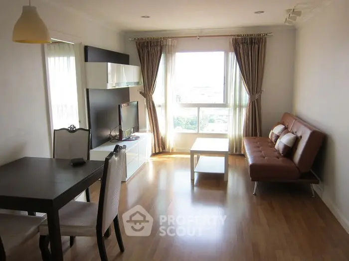 Bright and modern living room with wooden flooring and stylish furniture.