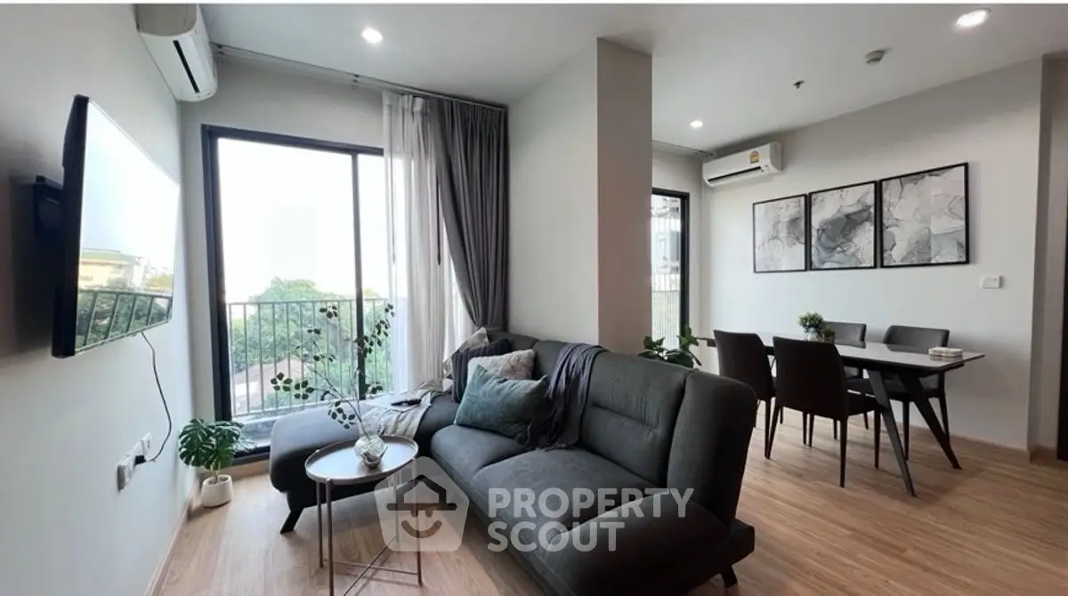 Modern living room with stylish furniture and large windows offering natural light.