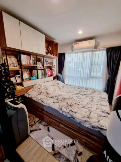 Cozy bedroom with stylish decor and ample natural light