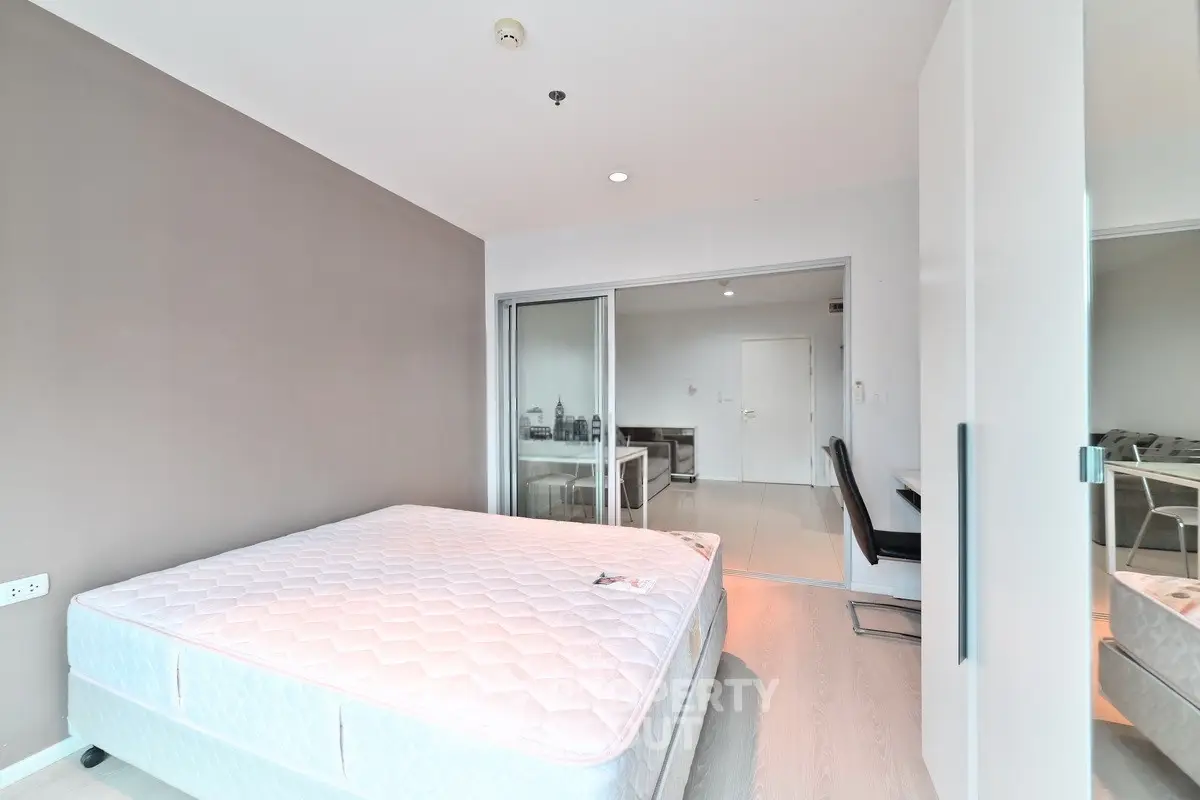 Spacious modern bedroom with large window and minimalist decor