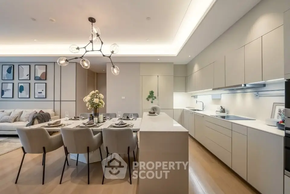 Luxurious open layout kitchen and dining area with modern lighting and elegant decor.