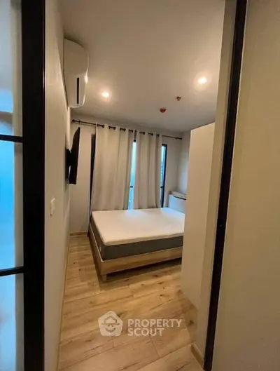 Cozy modern bedroom with wooden flooring and minimalist decor