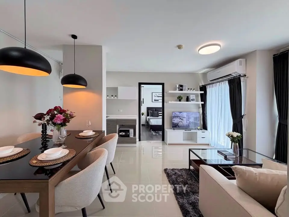 Modern open-plan living room with elegant dining area and cozy seating.