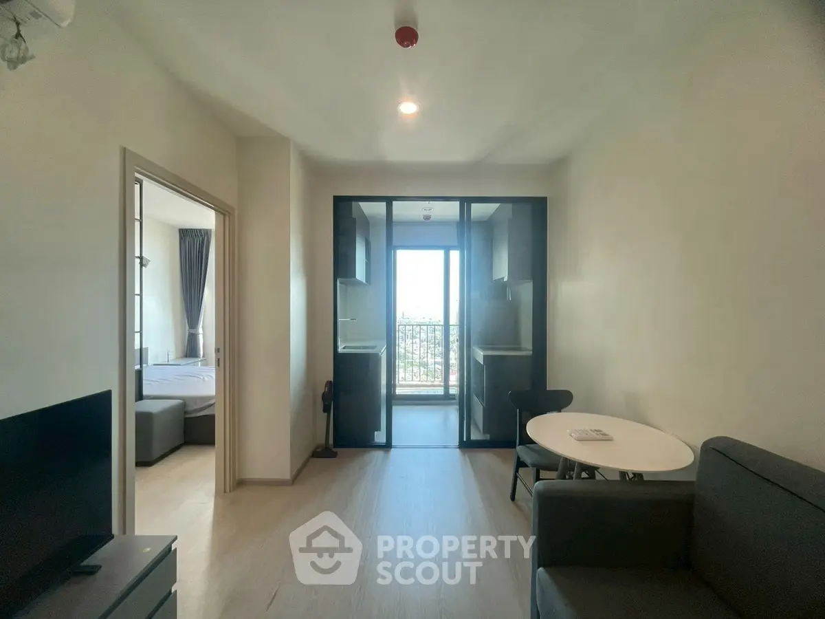 Modern apartment interior with open living space and balcony view