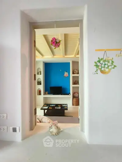 Charming living room with vibrant blue accent wall and cozy decor