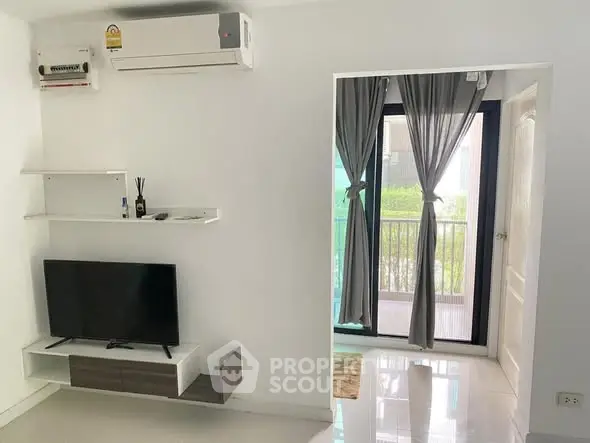 Modern living room with balcony access and sleek TV setup