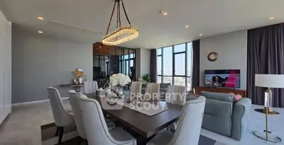 Luxurious open-plan living and dining area with elegant decor and stunning city views.