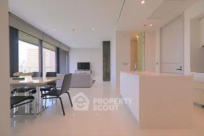 Modern open-plan living room with sleek kitchen and city view