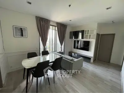 Modern living room with elegant dining area and large window view