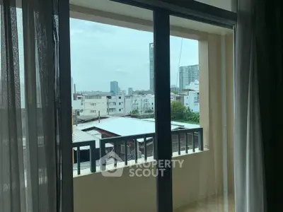 Charming balcony view with cityscape backdrop, perfect for urban living enthusiasts.